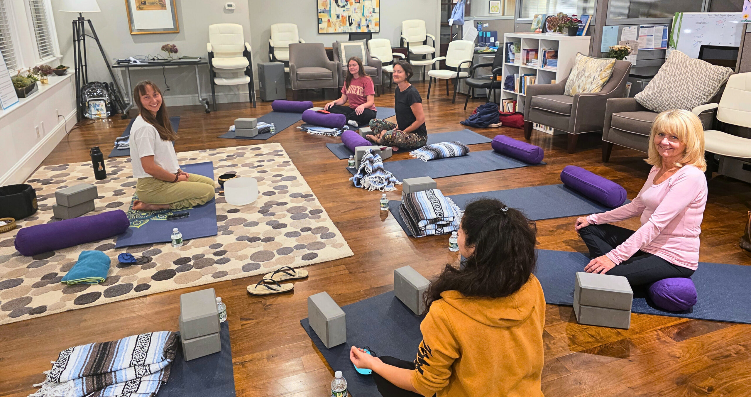 20250918_191646 - Edited Women practicing yoga together and sitting in the lotus pose.